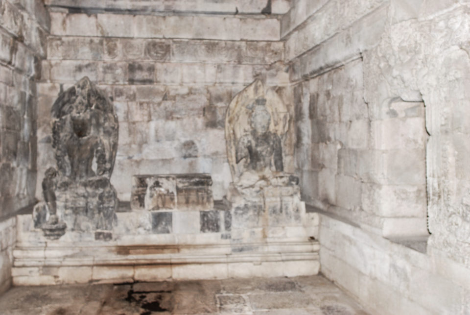 Two Bodhisattva statues with the center one missing in one of the main temples
